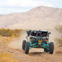 This image shows the 35x10r15 System 3 RX600 Rally Cross tires installed on a Can-Am Maverick X3 racing UTV. This action shot shows off the Rally Cross design in it's natural habitat, tearing up the trails.
